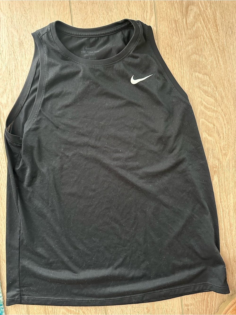 The Nike Tee women size large with White Swoosh